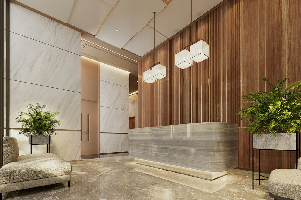 Hotel lobby with a marble reception counter, wood-slatted wall and planters