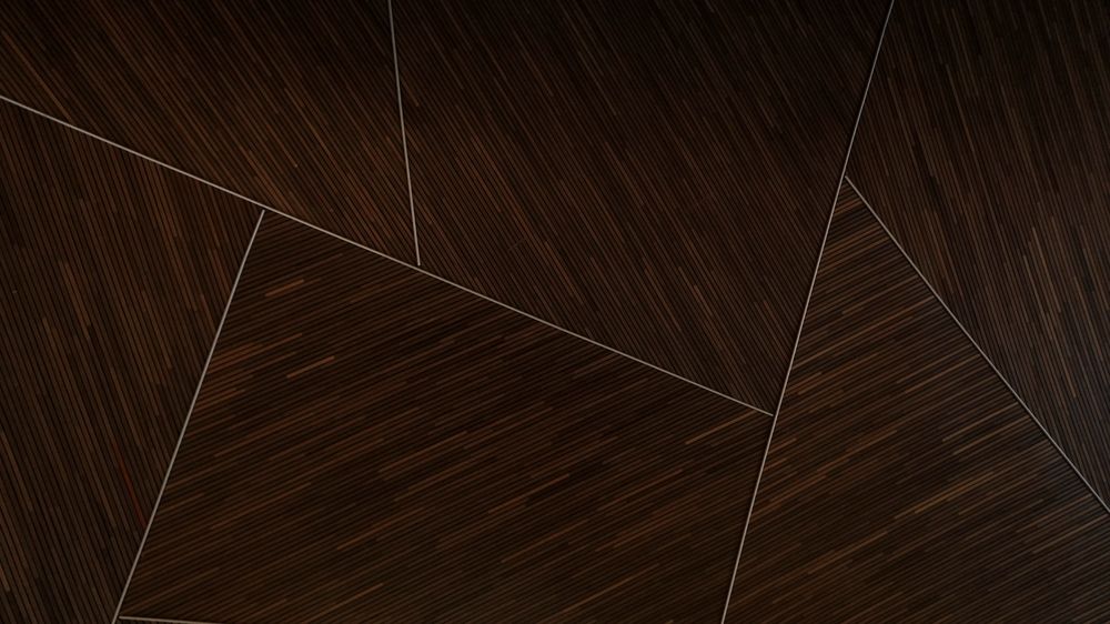 Dark wood veneer laid in angled panels, separated by thin metal inlay lines.